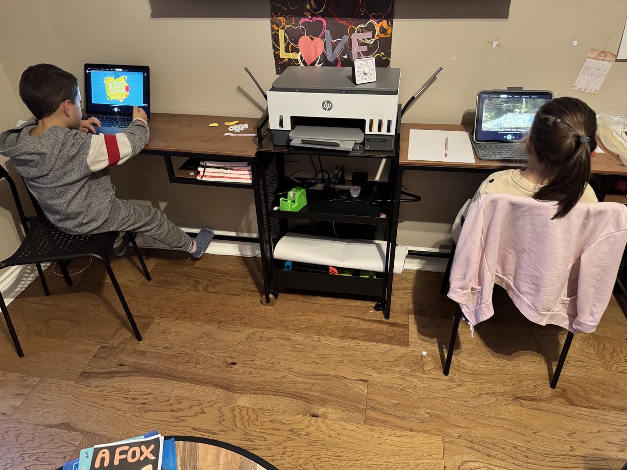 Two kids watching Picked — one on laptop, one on tablet